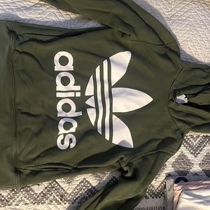 Army green adidas hoodie.